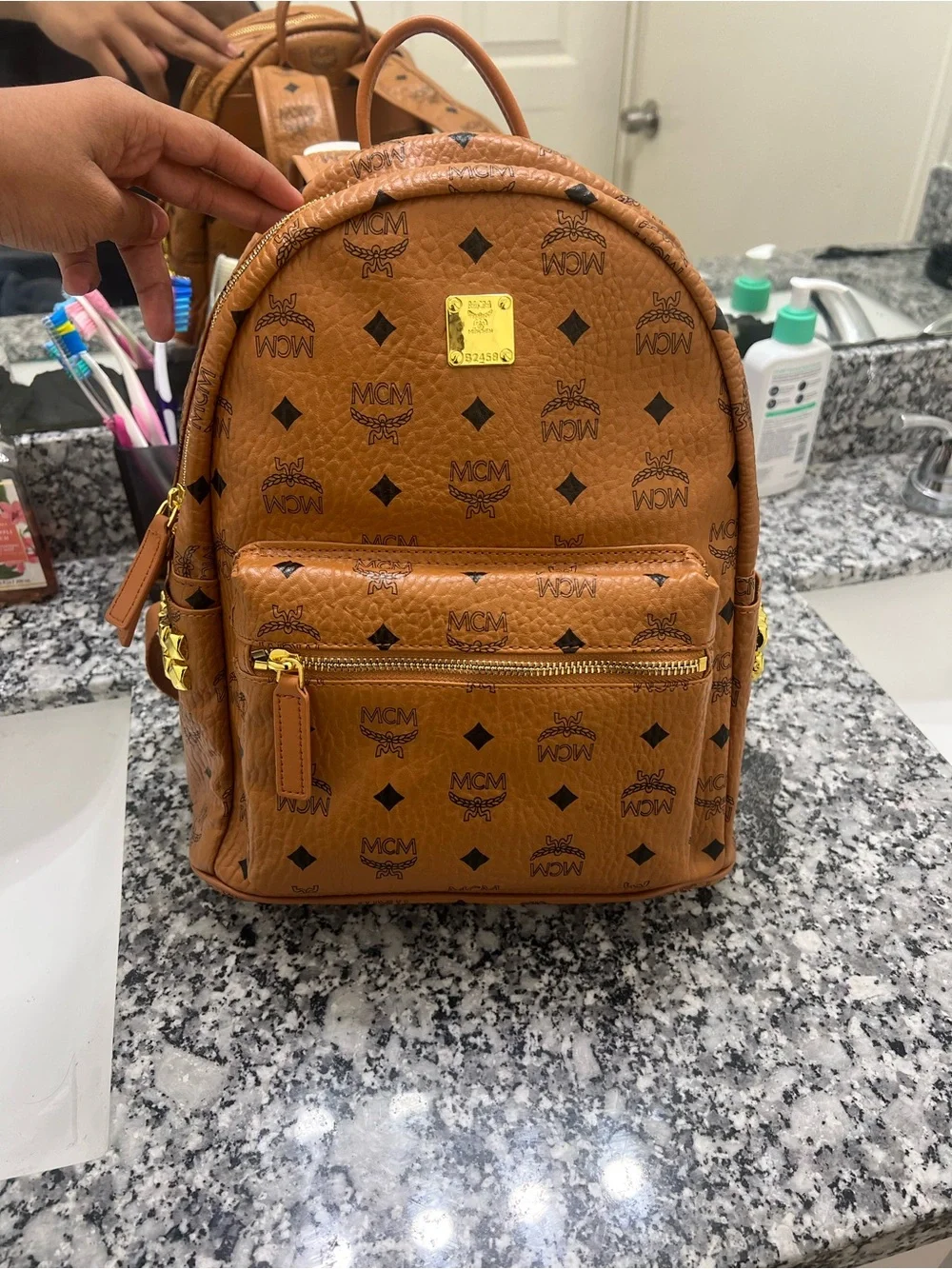 MCM Cognac Monogrammed Leather Mini Backpack with Gold Plaque